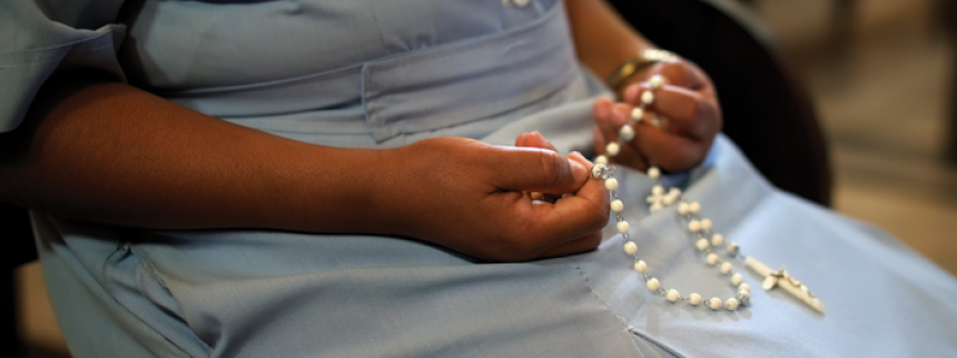 woman holding rosary