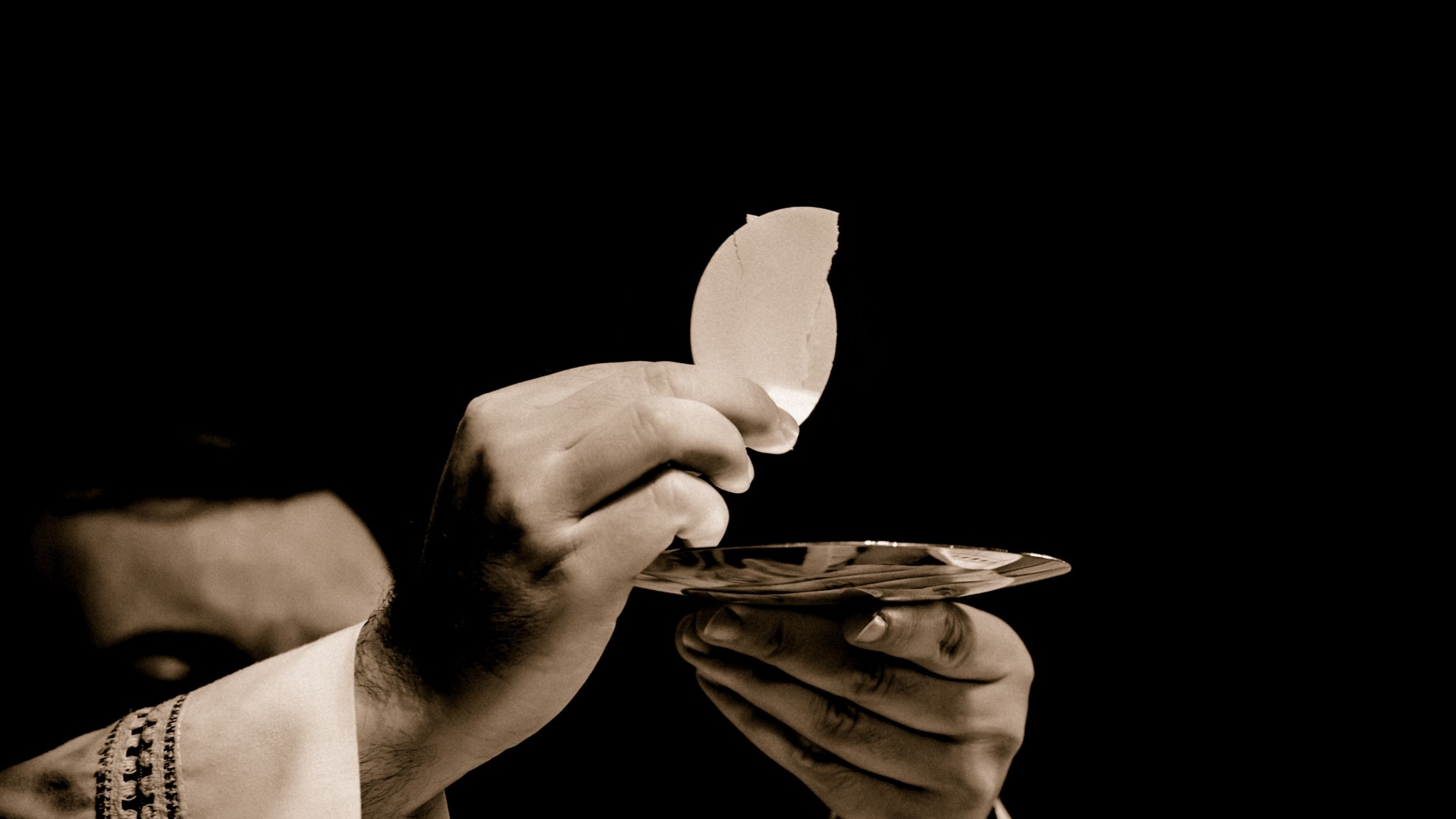 Priest holding Eucharist